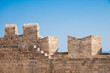 view of medieval castle’s wall on the background of blue sky, Rhodes, Greece