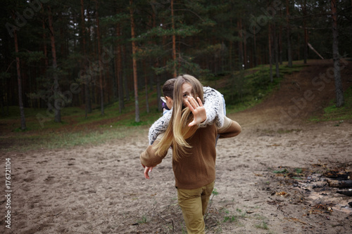 Woman Carrying Man Over Shoulder