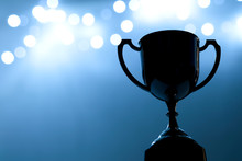 Silver Trophy Competition In The Dark On The Abstract Blurred Light Background With Copy Space, Blue Tone