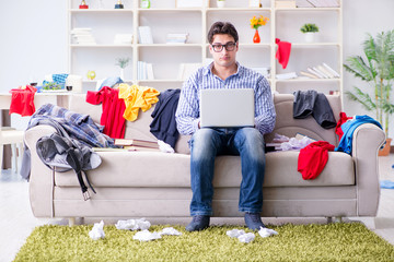 Canvas Print - Young man working studying in messy room