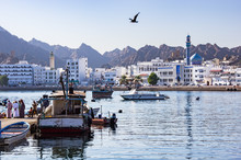 Fishermen At The Muttrah Fish Docks With Muttrah Corniche In The Background - Muscat, Oman