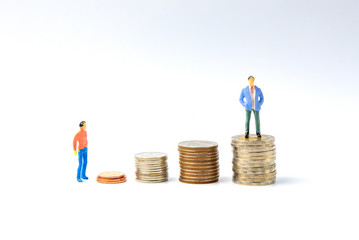 Concept for success ladder Miniature people: Small business figure standing on stack of coin. Money and financial concepts