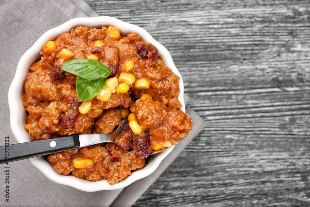 Bowl with chili con carne on table