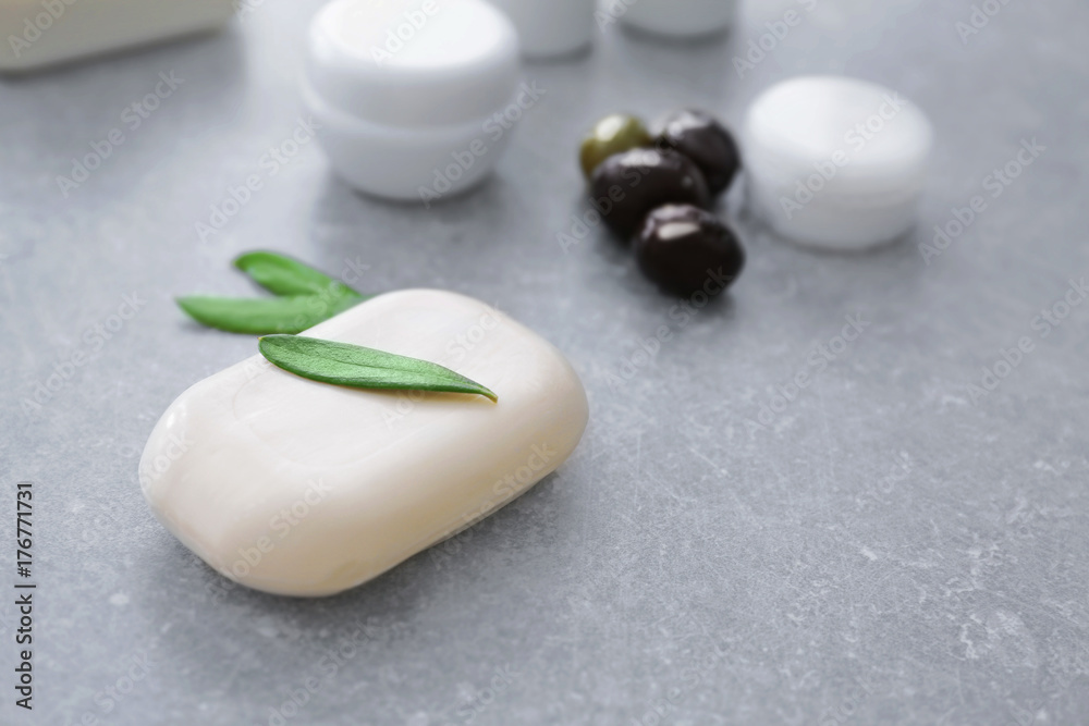 Cosmetics with olive oil extract on grunge table