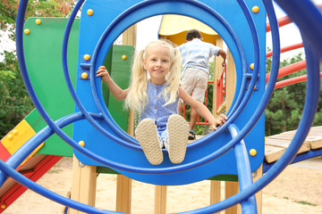 Wall Mural - Cute little girl on playground