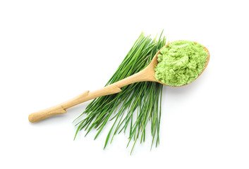 Wall Mural - Spoon with wheat grass powder and sprouts, isolated on white