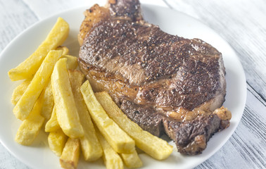 Canvas Print - Beef steak with fried potatoes on the plate