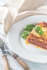 Poster - Portion of lasagne on the wooden table