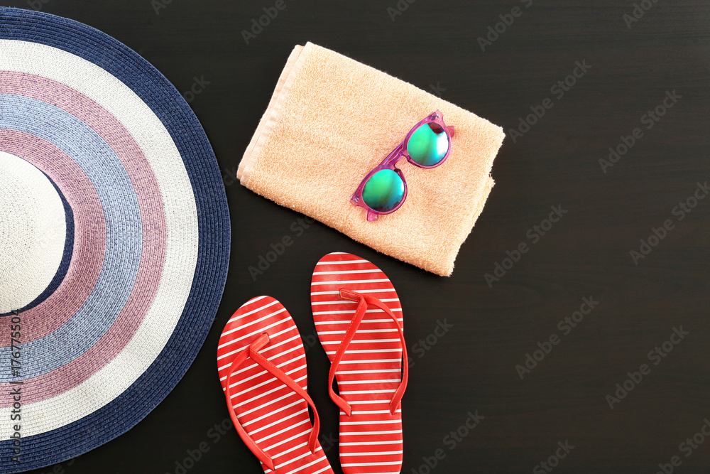Composition with towel and summer accessories on dark background