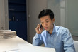 © Quang - Office worker answering phone call from customers