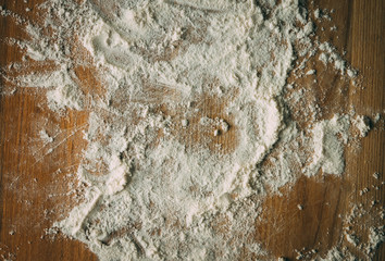 White flour on a wooden cooking desk. Abstract texture.