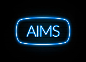 Aims  - colorful Neon Sign on brickwall