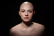 Portrait of a bald girl on a black background.