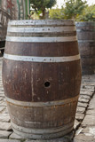 Fototapeta  - An old wine barrel which is used as a bar table in the daytime on the street