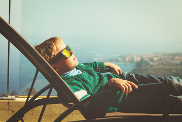 little boy relax on balcony with scenic view