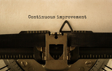 Text Continuous improvement typed on retro typewriter