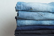 © ytochka89 - a stack of jeans of different colors close up.
