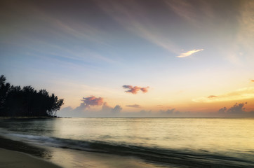 beauty in nature, silhouette image of beach scenery during sunrise. cloudy sky and soft wave htting  sandy beach