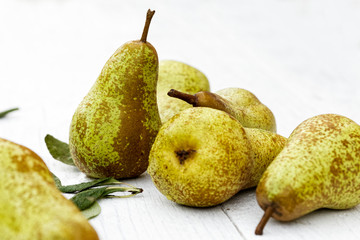 Wall Mural - Abate fetel pears with leaves on white painted wood.