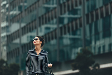 Wall Mural - Young businesswoman walking outdoors