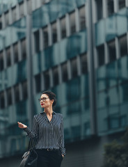 Wall Mural - Young businesswoman walking outdoors