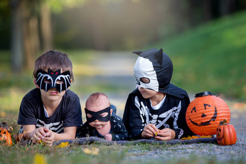 Wall Mural - Two children, boy brothers in the park with Halloween costumes