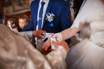 hands of young couples in the church