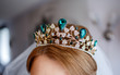 beautiful crown with a green stone in the hair for the bride