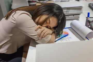 Young businesswoman sleeping on the desk