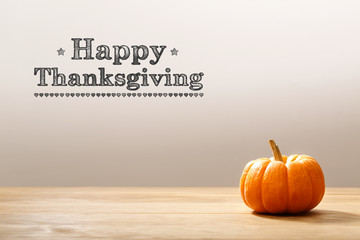 Wall Mural - thanksgiving message with a orange small pumpkin