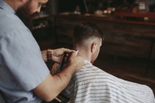 Detail Shot Of Barbers Hands Working On Classic Mens Haircut