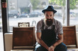 © Rob and Julia Campbell/Stocksy - Portrait of stylish 30-something man with beard - indoors