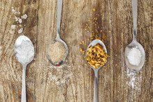 Closeup Of Four Teaspoons Of Different Kinds Of Sugar