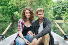 Portrait Of Good-Looking Young Couple Sitting In Rowboat