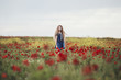 © Jovana Rikalo/Stocksy - Girl in a field of poppies