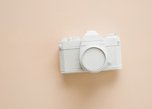 A Painted White Camera On Cream Color Background