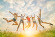 © realstock1 - The five friends jumping on the grass on the sunny background