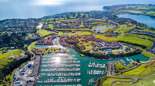 aerial view on residential suburbs surrounded by sunny ocean harbour. whangaparoa peninsula, aucklan