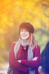 Sticker - woman in red coat and hat have a rest in autum park