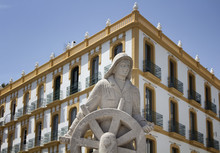 Close Up View Of Sailor Sculpture In Downtown Of Ibiza. Old, Histrorical Building Is In The Background.