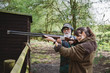 © kkgas/Stocksy - Young girl learning to fire a shoot gun in a firing range with an instructor .