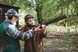 © kkgas/Stocksy - Young girl learning to fire a shoot gun in a firing range with an instructor .
