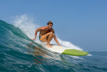Surfer Riding Wave In Board Shorts