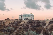 Bus Sitting On Top Of Sand Dunes During Sunrise