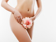 © looking2thesky - Women health and intimate hygiene. Beautiful Woman's body with smooth soft skin with flower. Epilation Concepts