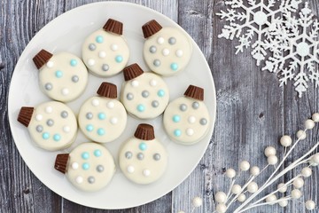 Christmas white chocolate ornament cookies, overhead scene on a rustic gray wood background