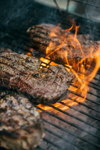 Steak Cooking Over Charcoal Grill