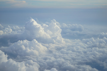 Wall Mural - view of beautiful free form heaven white cloud with shades of blue sky background from flying plane 