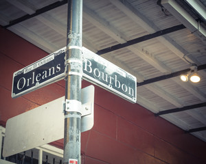 Bourbon Street Sign in New Orleans, the world famous Bourbon Street at French Quarter as party atmosphere. Vintage tone.