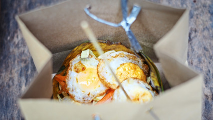 fried quail eggs in brown paper bag